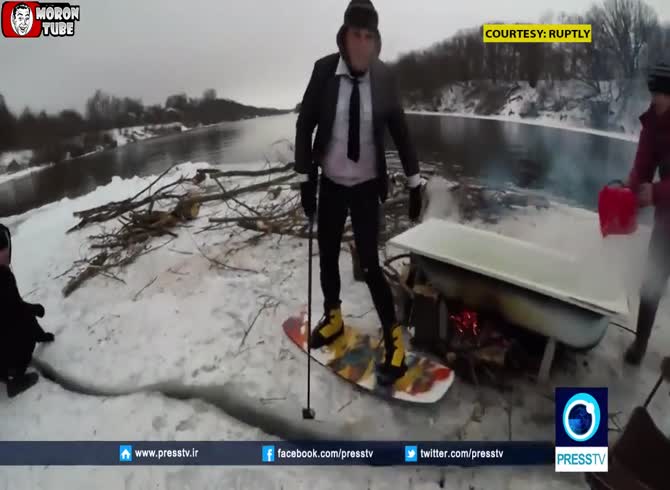 Video :Russians float along a river in a raft they had carved out of ice